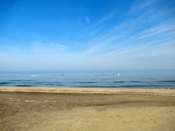 Scenic view of beach against blue sky