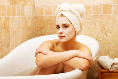 Portrait of young woman in bathroom