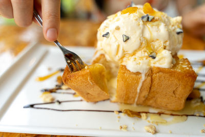 Close-up of hand holding ice cream