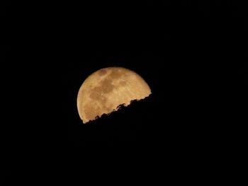 Low angle view of moon in the dark