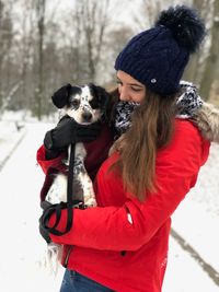 Woman with dog on snow