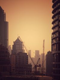 View of buildings against clear sky during sunset