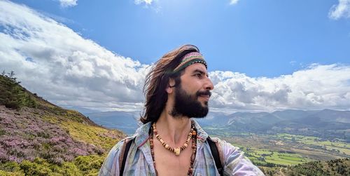 Young woman standing against mountain