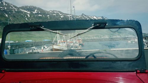 Cars on mountain against sky