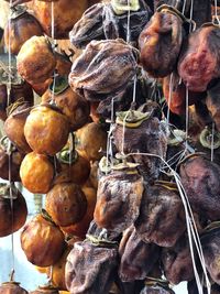 Rotten fruits hanging at market for sale
