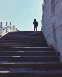 Low angle view of man walking up stairs