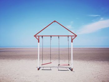 Lifeguard hut on beach against sky