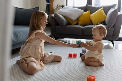 High angle view of mother playing with toy at home