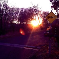 Road sign at sunset