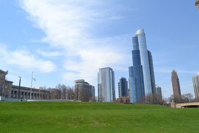 View of skyscrapers against cloudy sky