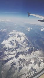 Aerial view of airplane wing over landscape