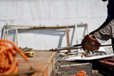 Low section of man working on wood