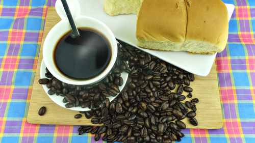 High angle view of coffee and bread on table