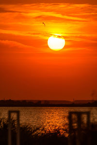 Scenic view of sea against orange sky