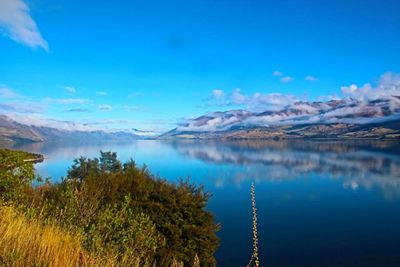 Scenic view of lake against blue sky