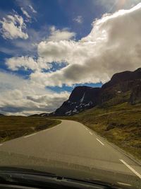 Road against sky seen through car windshield