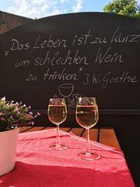 Close-up of wine glasses on table