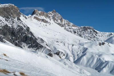 Scenic view of snow mountains against sky