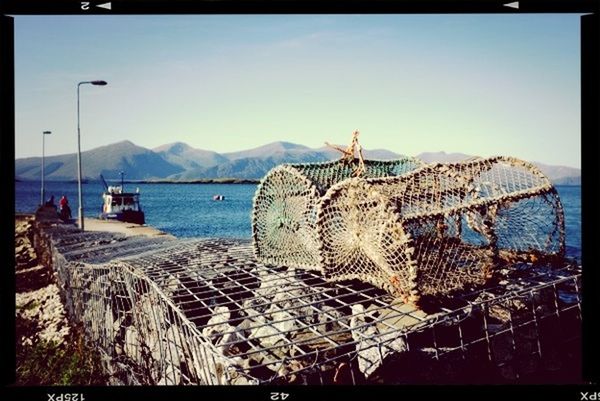 transfer print, auto post production filter, sea, water, sky, mountain, tranquility, scenics, tranquil scene, beach, day, nature, clear sky, outdoors, sunlight, panoramic, protection, nautical vessel, built structure, shore