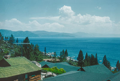 High angle view of townscape by sea against sky