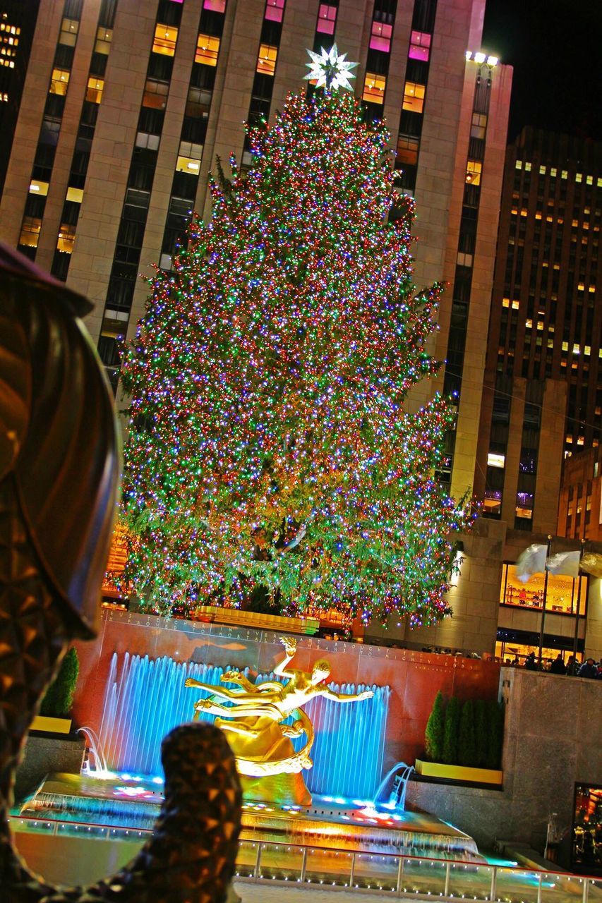 LOW ANGLE VIEW OF ILLUMINATED CHRISTMAS DECORATIONS AGAINST SKY