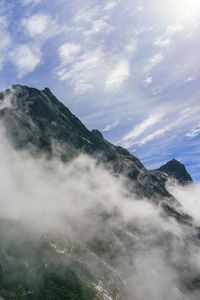 Low angle view of waterfall against sky