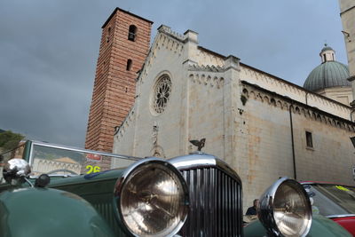 Close-up of vintage car with mosque in background