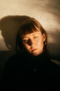 Portrait of teenage boy sitting against wall