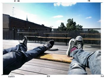 Low section of man sitting on bench