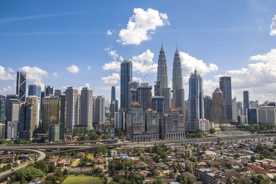 View of skyscrapers against cloudy sky