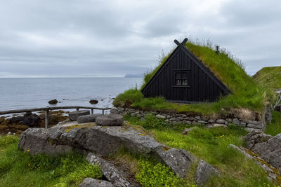 House by sea against sky