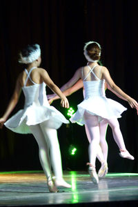 Happy young woman standing on stage