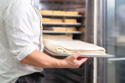 Midsection of man working on table at store