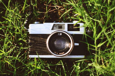 High angle view of vintage camera on grassy field