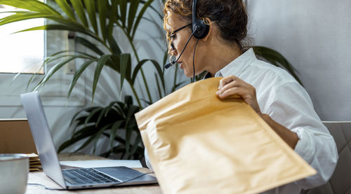 Side view of man using laptop on table