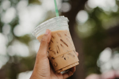 Close-up of hand holding drink