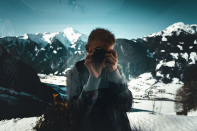 Woman standing on snow covered mountains