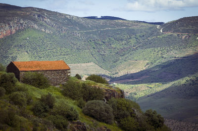 High angle view of land and mountains against sky