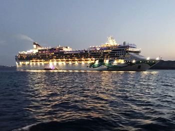 Ship in sea with city in background