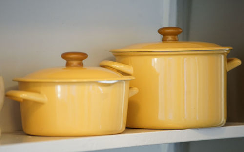 Yellow pots on the kitchen shelf