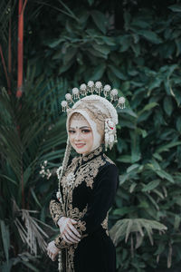 Portrait of smiling young woman standing outdoors