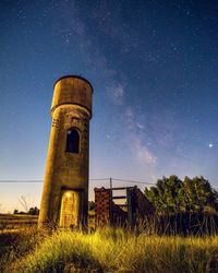 Low angle view of old building against sky at night