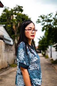 Portrait of beautiful young woman standing outdoors