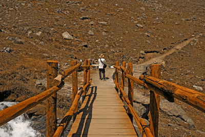 High angle view of people walking on footbridge