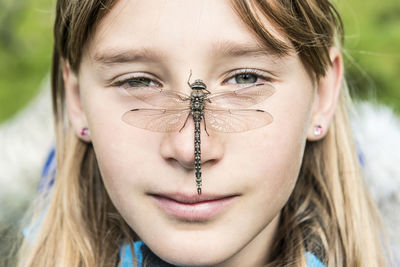 Dragonfly on girls face
