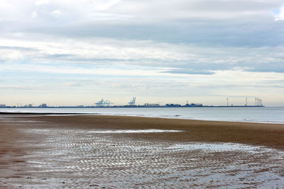 Scenic view of beach against sky during winter