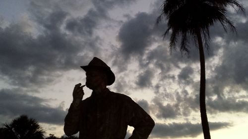 Low angle view of silhouette man against cloudy sky