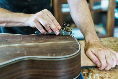 Cropped hands of man playing drum