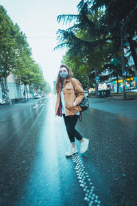 Man walking on road in city