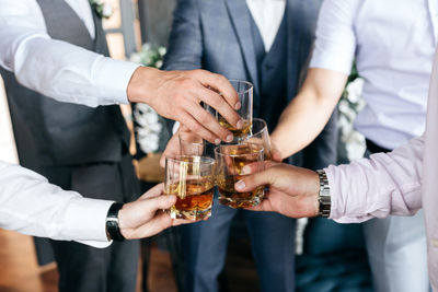 Midsection of man holding drink